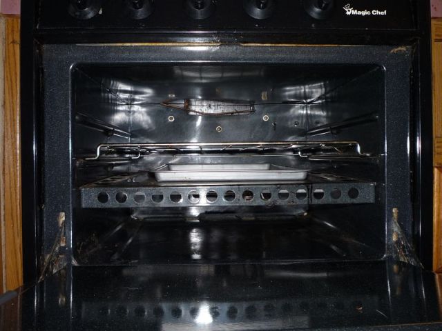 Oven with inverted rack and cookie sheet underneath.