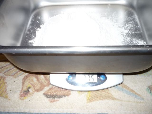 Weighing flour into pan.