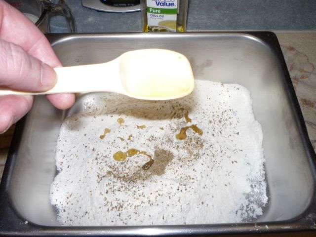 Adding olive oil to flour.