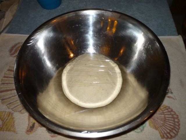 Three pound ball of dough in large mixing bowl, covered.