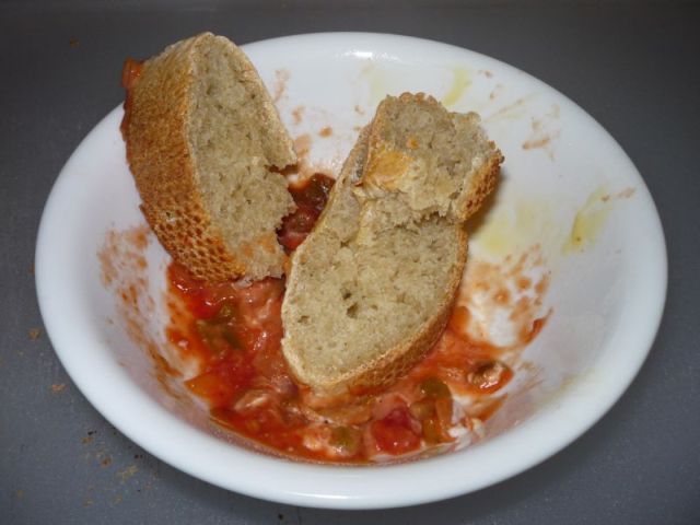Chunks of bread dipped in some picante salsa.