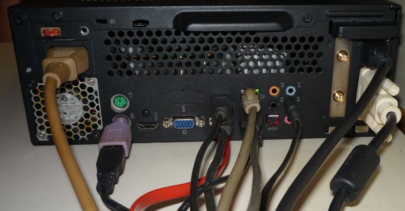 back of computer, showing a bunch of cables