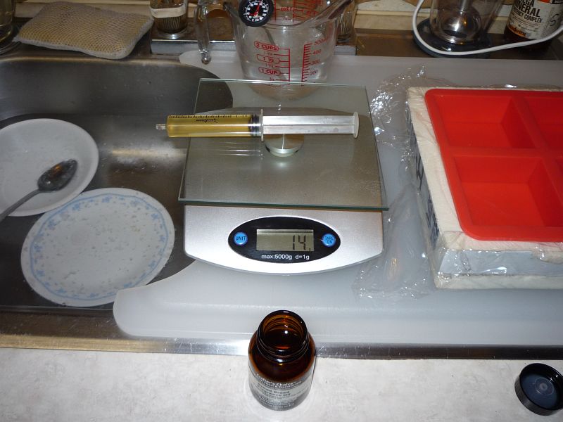 14 c c syringe on scale, reading 14 grams