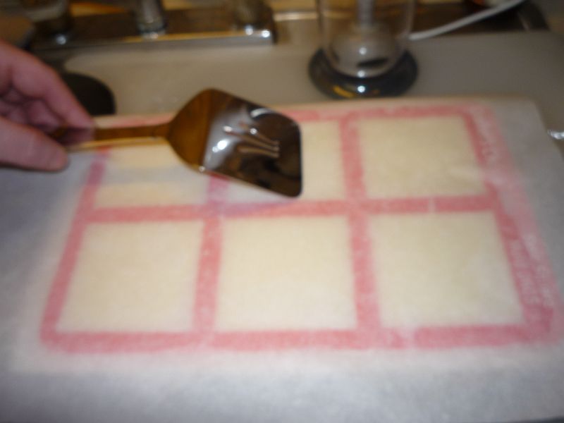 covering mold with paper and smoothing top with a spatula